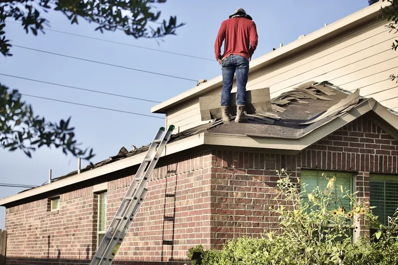 Professional roofer working on a residential roof in Drummersville